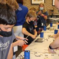 Students work on their bee house projects